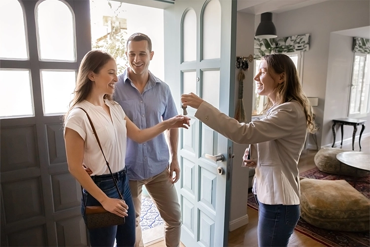 Real estate agent handing keys to home buyers for O’Reilly Realty Group buyer services in Mansfield TX and DFW